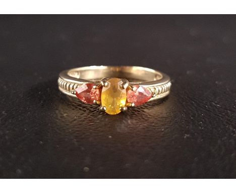 YELLOW AND ORANGE GEM SET RINGthe central oval cut yellow gemstone flanked by pear cut orange gemstones, on nine carat gold s