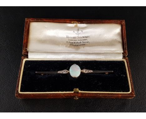 EDWARDIAN OPAL AND DIAMOND BAR BROOCHthe central oval opal flanked by diamonds, in unmarked gold, 6.3cm long, in fitted box m