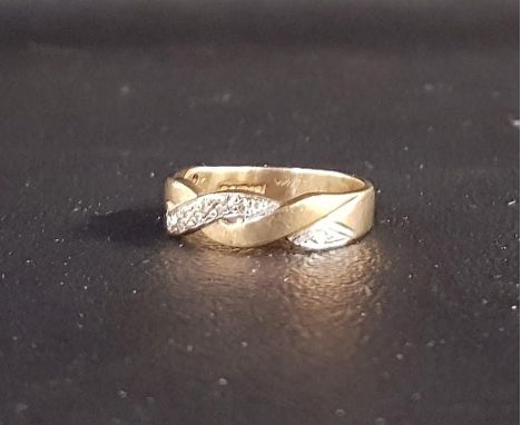 DIAMOND SET NINE CARAT GOLD RINGof entwined design, ring size K-L and approximately 2.8 grams 