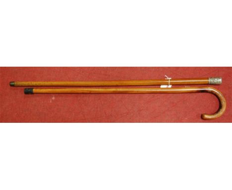 **one with inset lighter in top** A circa 1900 walking stick, having a mallacca shaft and white metal terminal; together with