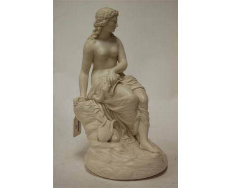 An early 20th century ceramic figure of a partially clad female seated on a rocky outcrop