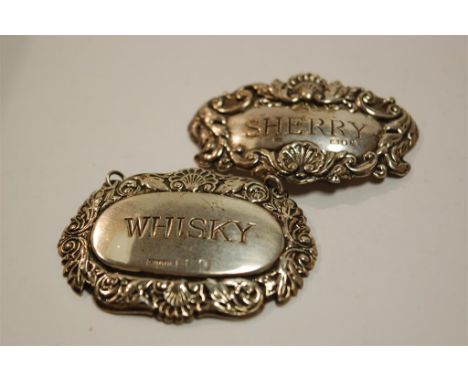 A pair of silver and embossed decanter collars annotated whisky and sherry