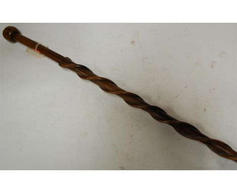 An early 20th century rosewood walking stick, the shaft having entwined serpent decoration 