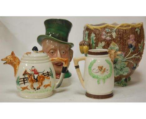 A Majolica jardiniere, relief decorated with acorns; together with a Beswick Micawber character jug; a teapot and cover and m