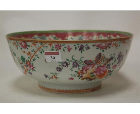 An early 19th century porcelain bowl, enamel decorated with butterflies and flowers, on a footed rim, probably Samson 
