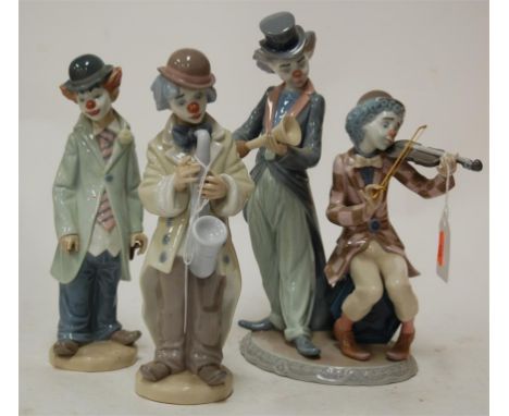 A Lladro figure group of clown musicians together with two others similar (3)