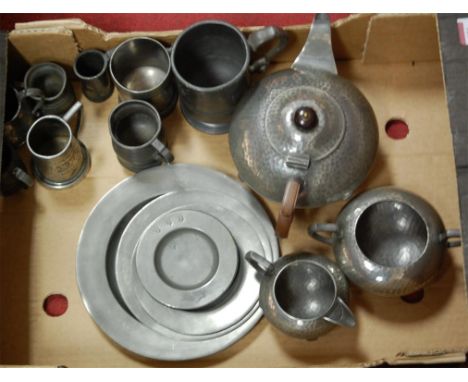 An Arts & Crafts hammered pewter three piece tea service; together with various pewter tankards and plates etc 