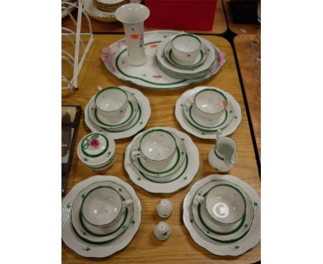 A Herend porcelain part tea service, on a plain white ground with hand-painted floral decoration, within green borders 