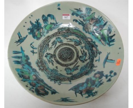 An 18th century Chinese stoneware shallow bowl, the central panel decorated with mythical figures within landscape borders, d