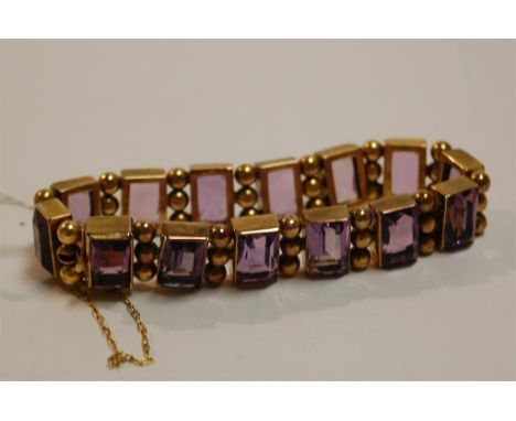 A yellow metal and amethyst set hinge bracelet Condition Report / Extra Information General surface scratches to stones.Other