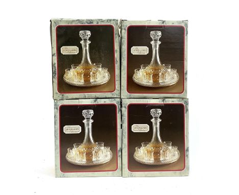 Four boxed 'The Jewellers Collection' crystal decanters and glasses with silver plated tray