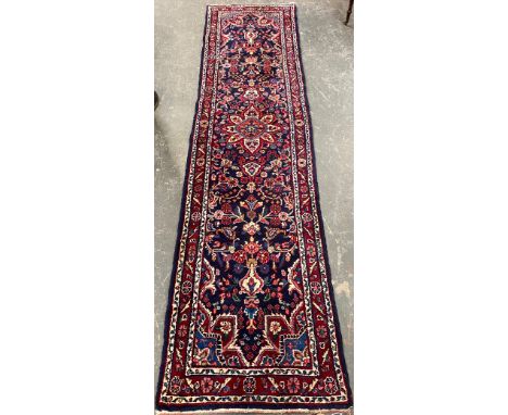 A red ground runner rug, 315x80cm