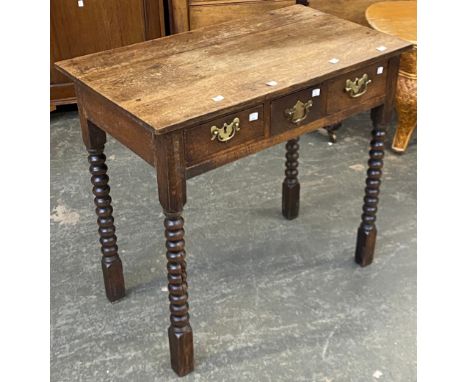 An oak lowboy or side table, with three drawers, on bobbin turned legs, 80x46x75cmH