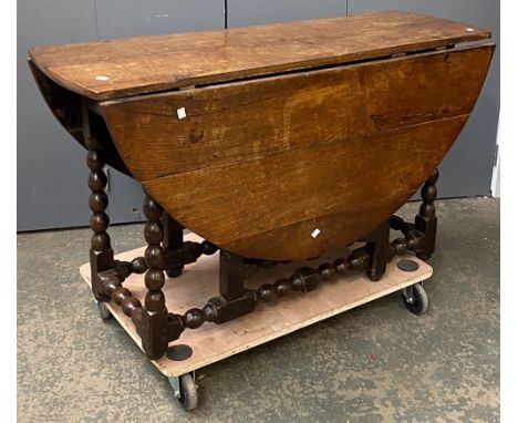 An 18th century oak oval gateleg table, on bobbin turned supports and turned peripheral stretchers, approx. 122cmL
