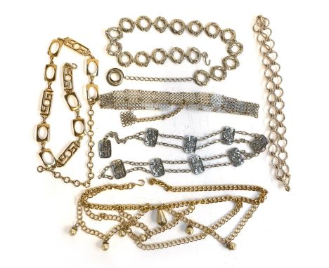 Four vintage silver tone belts, one with playing card design panels; together with gold tone belts, one with faux pearl swag 
