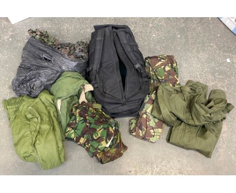 A large quantity of army surplus to include quilted jackets, camo netting etc