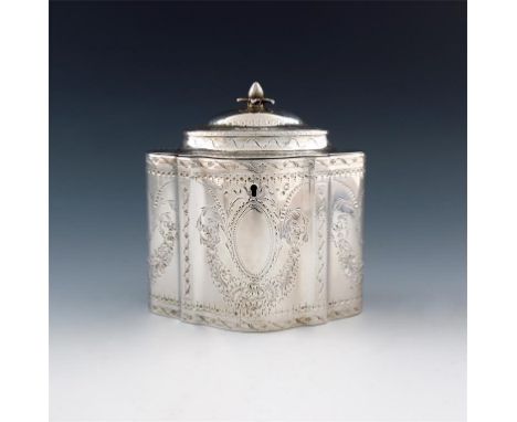 A George III silver tea caddy, by Robert Hennell, London 1784, shaped oval form, bright-cut foliate decoration, with two vaca