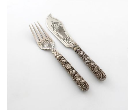 A pair of Chinese silver fish servers, by Luen WO, Shanghai circa 1900, the handles with birds in blossom on a matted backgro