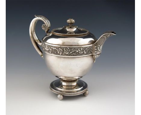 λ A George III silver teapot, by Emes and Barnard, London 1809, circular form, chased vine leaf girdle, on a matted backgroun