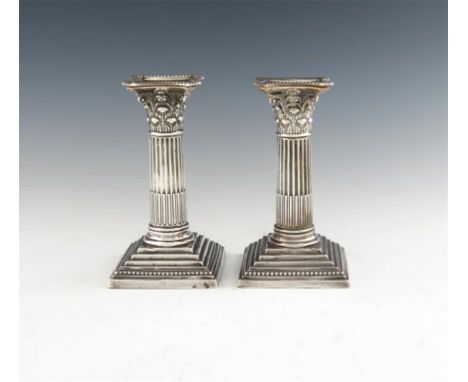 A pair of late-Victorian silver candlesticks, by William Hutton & Sons, London 1889, Corinthian column form, with beaded bord