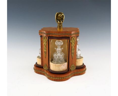 A French revolving wooden scent bottle case, shaped rectangular form, with gilt metal mounts and husk borders, the central br