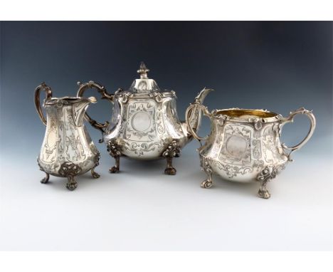 A three-piece Victorian silver tea set, by William Hunter, London 1856, panelled tapering circular form, engraved decoration,