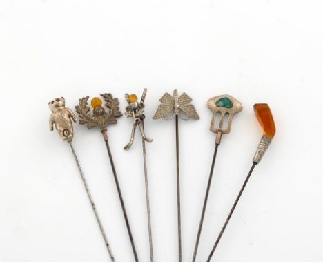 A collection of six silver hat pins, comprising four by Adie and Lovekin Limited, including: a teddy bear, Birmingham 1909, a