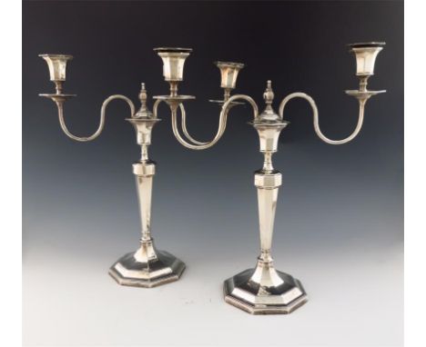 A pair of silver two-light candelabra, by H. Atkins, Sheffield 1929, tapering octagonal form, plain scroll branches, octagona