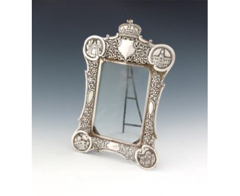 An Indian silver photograph frame,  unmarked, shaped rectangular form, pierced and embossed with foliate scroll decoration, t