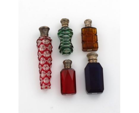 A collection of five Victorian silver-mounted coloured glass scent bottles, comprising: one with green overlay decoration, on