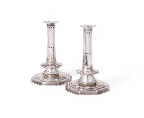 A PAIR OF WILLIAM AND MARY SILVER CANDLESTICKS PROBABLY BY THOMAS ASH, LONDON 1689 AND 1690 With octagonal sconces, tapering 