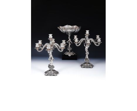 A PAIR OF SILVER SEVEN LIGHT CANDELABRA AND A PEDESTAL BOWL PROBABLY EGYPTIAN, .800 STANDARD The candelabra with circular sco