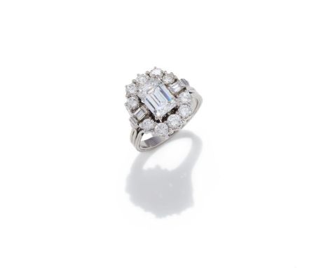 A DIAMOND CLUSTER RING  The rectangular step cut diamond with canted corners, weighing 2.48 carats, within a brilliant cut di