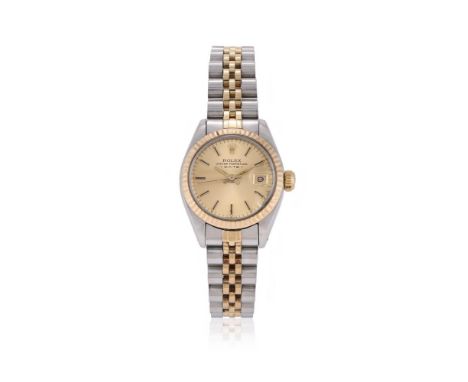ROLEX, OYSTER PERPETUAL DATE, REF. 6917 A LADY'S BI-METAL BRACELET WATCH WITH DATE, NO. 7310031, CIRCA 1982Movement: Cal. 203