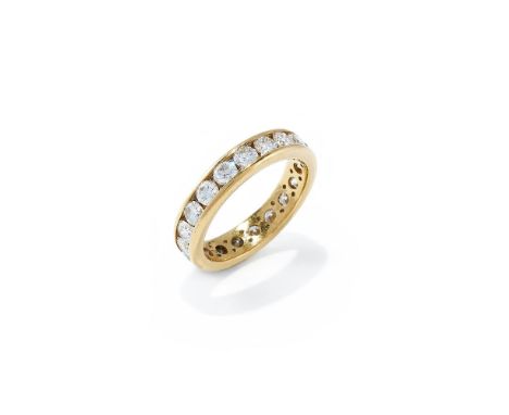 A DIAMOND ETERNITY RING  Channel set with a continuous line of brilliant cut diamonds, with smaller brilliant cut diamond acc