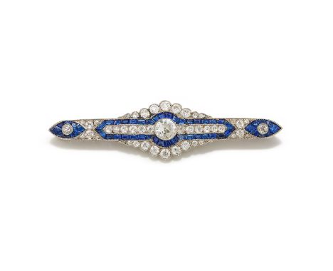 AN ART DECO SAPPHIRE AND DIAMOND BROOCH  CIRCA 1920 The central old European cut diamond millegrain set within a calibré cut 