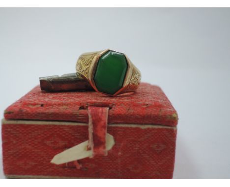 A Far Eastern yellow metal signet ring stamped 18 having plain octagonal jade panel, bearing Chinese makers mark to loop, siz