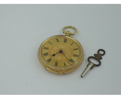 A Victorian yellow metal key wound pocket watch stamped 18K of small form, having Roman numeral dial to engraved face in exte