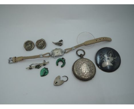 A small selection of white metal jewellery including Siam silver brooch/pendant, pocket watch case stamped 800, charms etc an