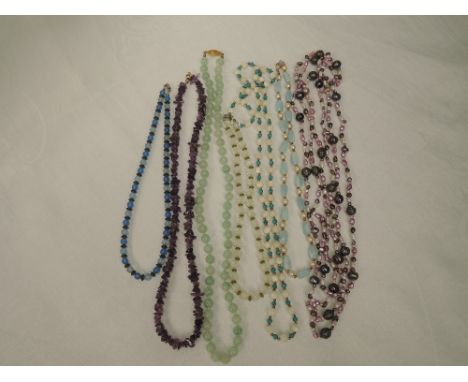 Seven strings of beads including polished amethyst style, crystal, jadeite style etc
