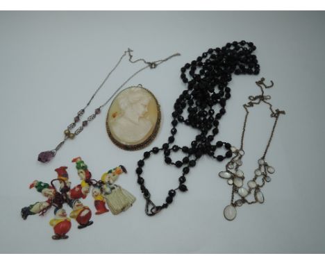 A selection of vintage jewellery including a large conche shell cameo brooch in rolled gold mount, two vintage necklaces, bla