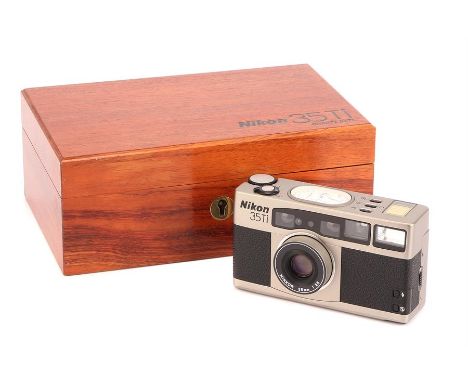 A Nikon 35Ti Compact Camera,titanium, serial no. 5006663, with Nikkor f/2.8 35mm lens, body, E, untested, lens, E, in wooden 
