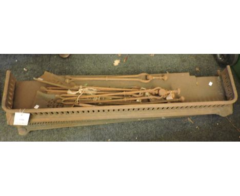 Two Victorian cast iron fenders, and tools