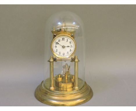An early 20th century brass anniversary clock, under glass dome, three small Royal Doulton character jugs, and two Japanese e