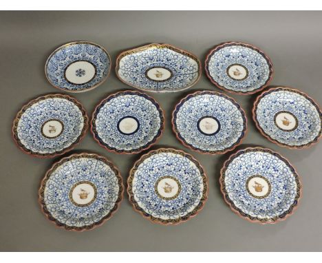 Worcester 'Royal Lily' pattern wares, eight dessert plates centred with a bird standing on a crown, in gilt, an oval dish, an