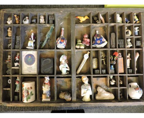 A print tray with contents, including china figures, brass dog's head box, miniature 'Ruskin' items, Wade animals, brass item