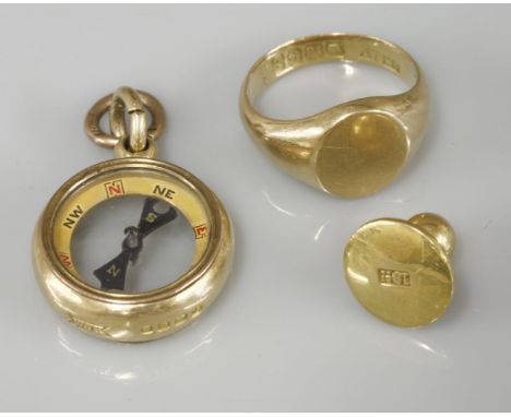 An 18ct gold compass fob, an 18ct gold oval signet ring, and a dress stud marked 18ct