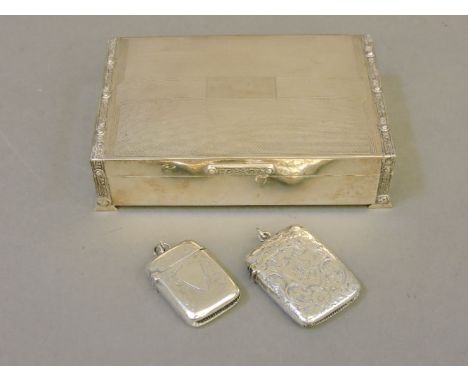 A silver cigarette box, by Charles S Green and Co, Birmingham 1955, with engine turned and Celtic band decoration on short br