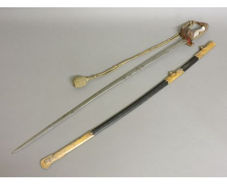 An Imperial German naval officer's sword and scabbard, the lion pommel with dual coloured eyes, a reeded ivory grip and Damas