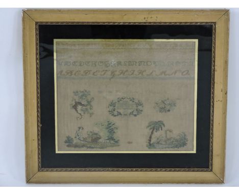 An English alphabet sampler, circa 1800, detailed with a gardener with wheelbarrow and a swan beside a palm tree, in a verre 